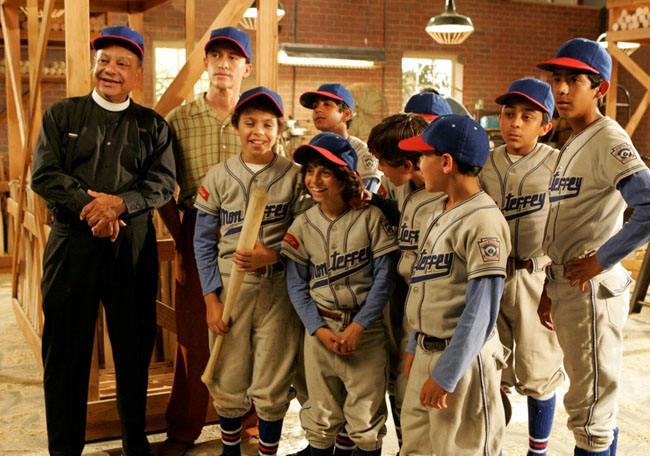 Cheech Marin (left) as Padre Estaban and Clifton Collins Jr. (next to Marin) as Coach Cesar with the Little Leaguers of ‘The Perfect Game’