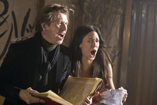 Rabbi Sendak (Gary Oldman) and Casey Beldon (Odette Yustman) attempt an exorcism.