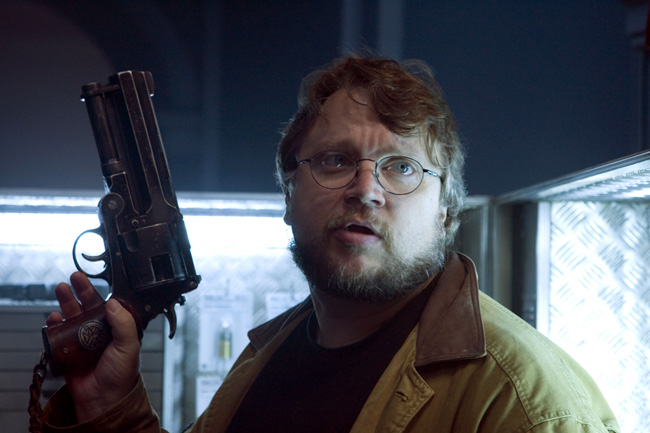 Writer and director Guillermo del Toro holds Hellboy's revolver on the set of Hellboy II: The Golden Army