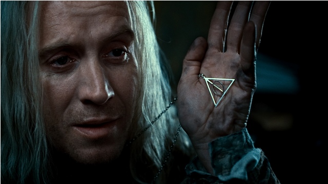 Rhys Ifans displaying the symbol for the Deathly Hallows in Harry Potter and the Deathly Hallows: Part 1